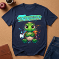 Navy blue t-shirt with a cartoon turtle graphic and text on a brown surface with accessories.