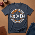 Navy blue t-shirt with motivational graphic on a brown surface with accessories.  Tee Says "Progress over zero, Keep it Positive" around "X>0" The math inequality.