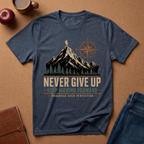 Hether Navy T-Shirt Graphic of a man hiking on a Mountain next to a compass symbol rising out of a pine forest.  Underneath it reads "Never Give Up, Keep Moving Forward, Progress over Perfection"