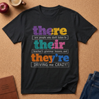black T-shirt Says There (Are people who don't listen to) Teir (teacher's grammer lessons, and) They're (DRIVING me CRAZY)