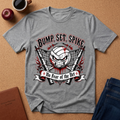 A heather gray graphic t-shirt laid flat on a cork background, featuring a volleyball-themed design with the text 'BUMP, SET, SPIKE' and 'No Fear of the Net'. The shirt is styled with a coffee cup, an apple, a journal, and jeans.