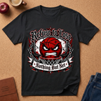 A black short-sleeve graphic T-shirt laid flat on a cork surface, featuring a red basketball face with a clenched jaw inside a white and red circular design, with the text 'Refuse to Lose' above and 'Nothing But Net' below. Surrounding props include a brown notebook, blue jeans, an apple, and a mug.
