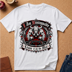A white short-sleeve graphic T-shirt laid flat on a tan cork-like surface, surrounded by small props including an apple, a cup, and jeans. The shirt features a large central bull-themed graphic with the text 'I Am Unstoppable' at the top and 'Leave it on the Mat' at the bottom.