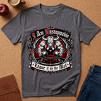 A dark gray graphic t-shirt laid flat on a cork background, featuring a muscular bull illustration with the text 'I Am Unstoppable' and 'Leave it on the Mat'.
