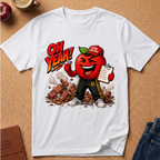 A white short-sleeve graphic T-shirt laid flat on a cork surface, featuring a cartoon red apple character wearing a 'Gym Teacher' cap and black pants, with the text 'OH YEAH!' and a clipboard.