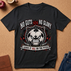 A black graphic t-shirt laid flat on a cork background, featuring a soccer-themed design with an angry soccer ball graphic, stars, and the text 'NO GUTS 424 NO GLORY' and 'LEAVE IT ALL ON THE PITCH'.