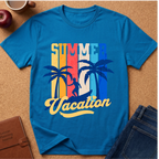 A bright blue short-sleeve t-shirt laid flat on a cork surface, featuring a retro-style 'Summer Vacation' graphic with palm trees and a sunset stripe design in yellow, orange, red, and blue. Styled flat-lay props include a brown leather journal, a dark apple, a coffee mug, and blue jeans.