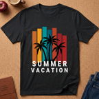 A black short-sleeve t-shirt laid flat on a cork background, featuring a retro graphic with vertical orange, teal, and red bars, black palm tree silhouettes, and the words 'SUMMER VACATION' in white. Styled flat-lay props include an apple, a coffee cup, a journal, and jeans.