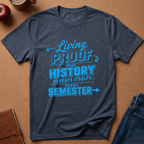 A heather navy blue graphic t-shirt with a bright blue text print reading 'Living PROOF THAT HISTORY REPEATS ITSELF.