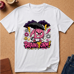 A white short-sleeve crewneck t-shirt laid flat on a cork background, featuring a colorful graphic of a pink brain character holding a black umbrella under dark clouds with the text 'BRAINSTORM!'.