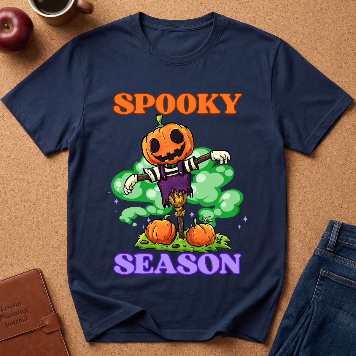 Navy Blue Spooky Season Pumpkin T-Shirt pairs a grinning jack-o’-lantern rising through green mist with scattered pumpkins and bold retro “SPOOKY SEASON” lettering. 