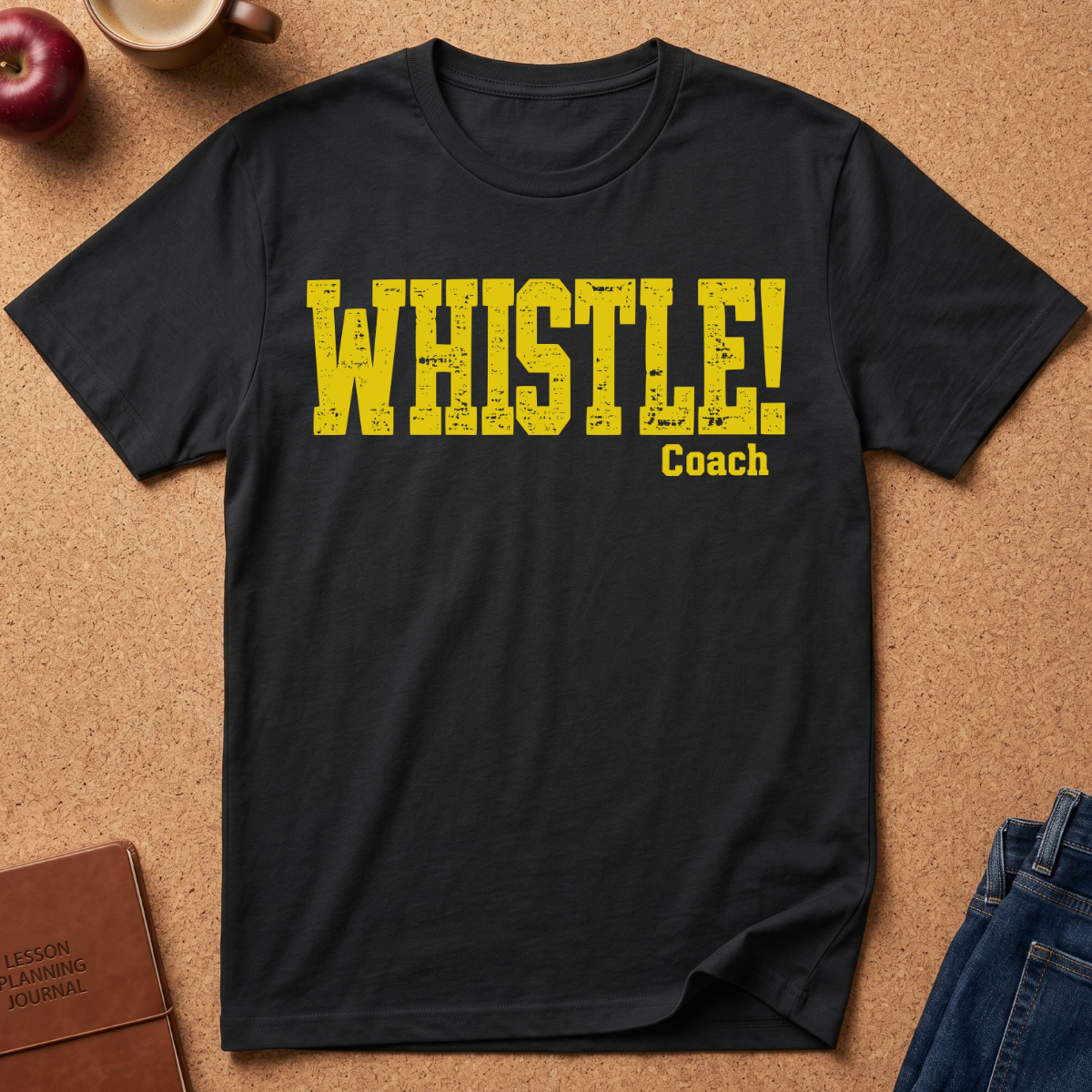 black Graphic Tee With the text "WHISTLE!" in a distressed yellow font, and then a second line saying "Coach" in a smaller script.