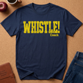 Navy Blue Graphic Tee With the text "WHISTLE!" in a distressed yellow font, and then a second line saying "Coach" in a smaller script.