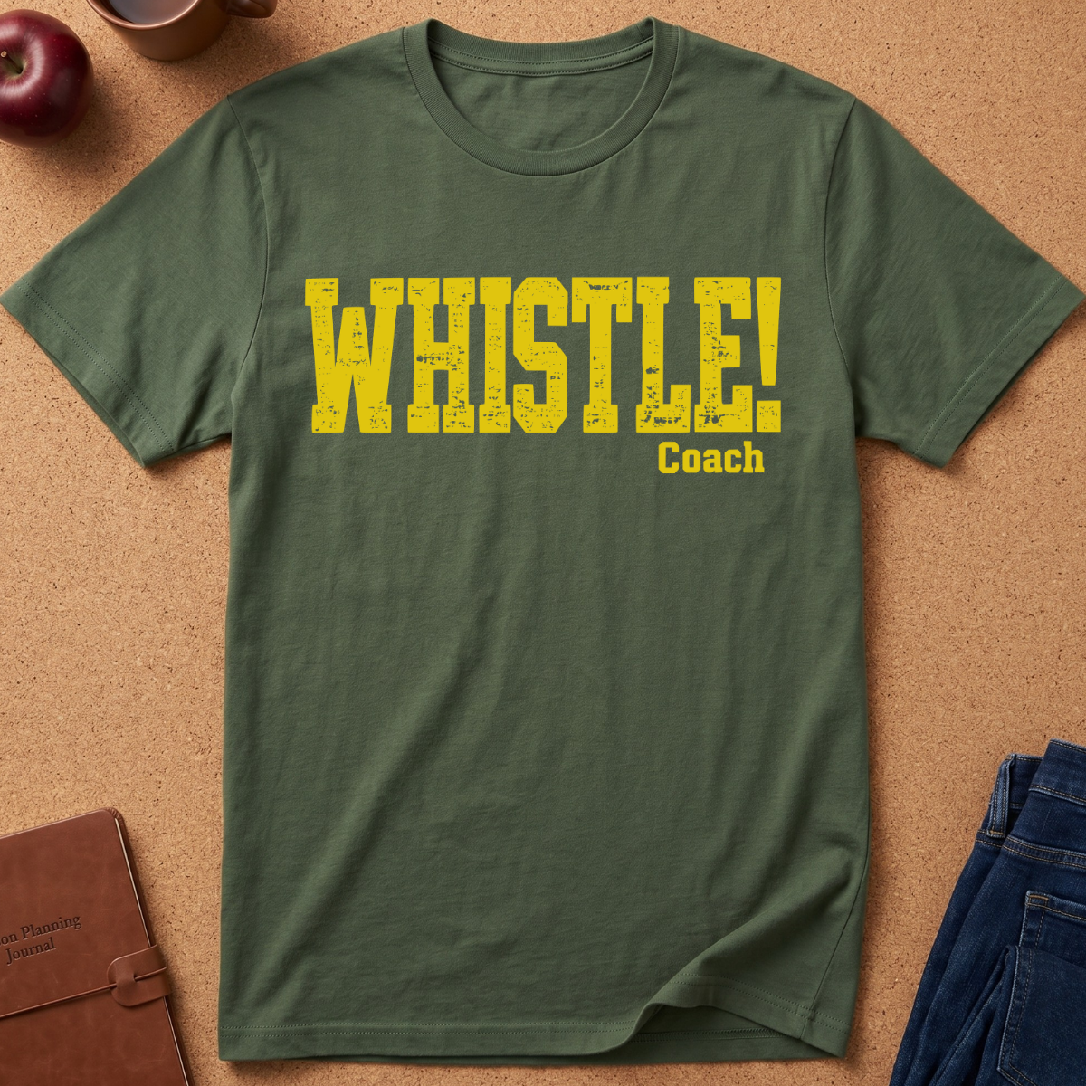 military Green Graphic Tee With the text "WHISTLE!" in a distressed yellow font, and then a second line saying "Coach" in a smaller script.