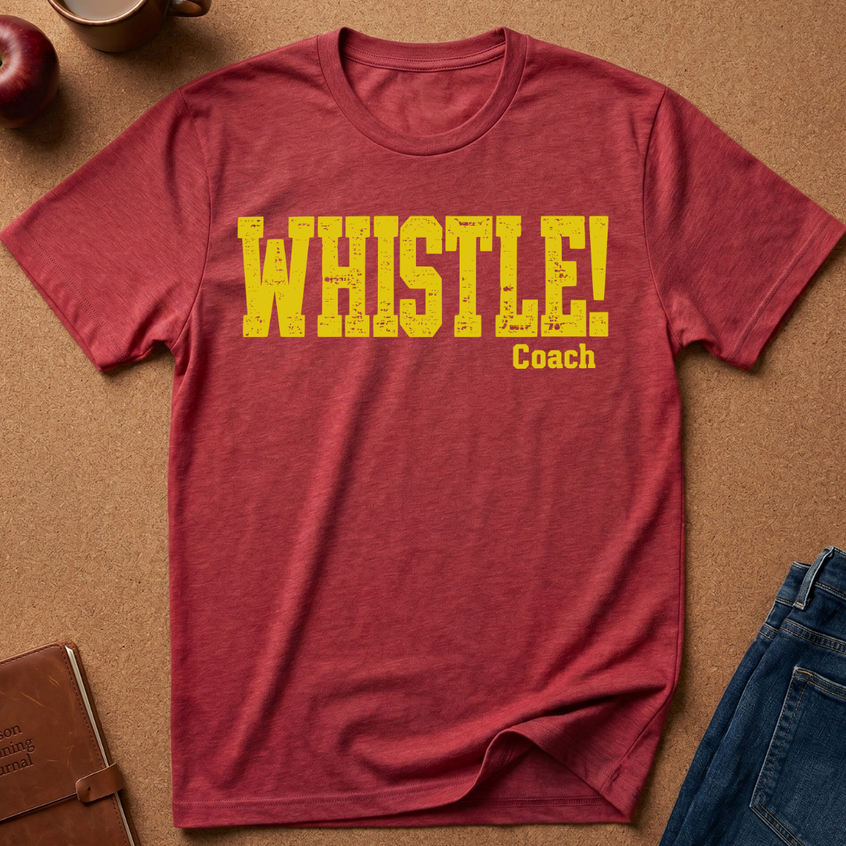 Red Heather Graphic Tee With the text "WHISTLE!" in a distressed yellow font, and then a second line saying "Coach" in a smaller script.
