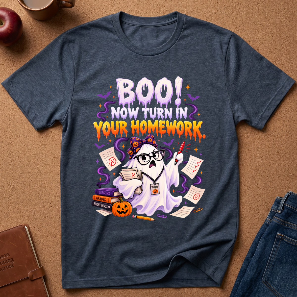 Heather Navy Graphic short sleeves T-Shirt with a cute ghost looking upset with a red pen and a pile of gra Ed homework, saying BOO, Now Turn In Your Homework.
