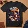 A black graphic t-shirt laid flat on a brown cork background, featuring a colorful cartoon illustration of a witch surrounded by ghosts and spooky elements with the text 'IF YOU THINK GHOSTS ARE SCARY TRY TEACHING ON A FULL MOON'.