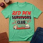 Green t-shirt with 'Red Pen Survivors Club' design on a cork background