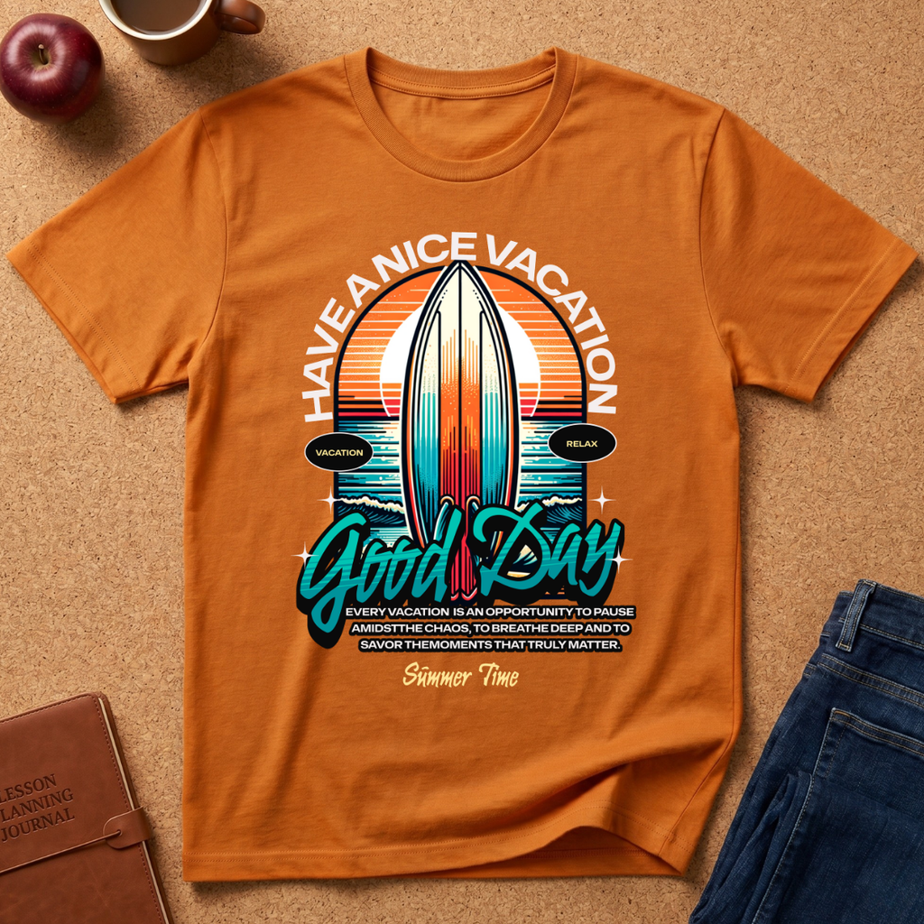 An orange short-sleeve graphic T-shirt laid flat on a cork surface, surrounded by a coffee mug, apple, notebook, and jeans. The shirt features a large retro surfboard and sunset print with the text 'HAVE A NICE VACATION Good Day' and smaller motivational text below.