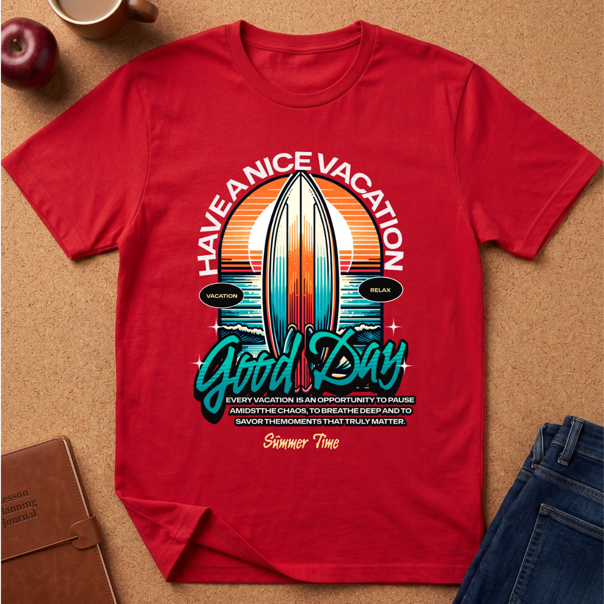 A red short-sleeve graphic T-shirt laid flat on a cork-like surface, with a large surfboard and sunset print reading “HAVE A NICE VACATION Good Day Summer Time.” Jeans, an apple, a mug, and a notebook are partially visible around it as styling props.