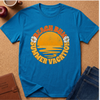 Saphire short-sleeve t-shirt laid flat on a cork background, featuring a retro-style yellow and orange graphic with the words 'BEACH BUM SUMMER VACATION' and small white flower illustrations.