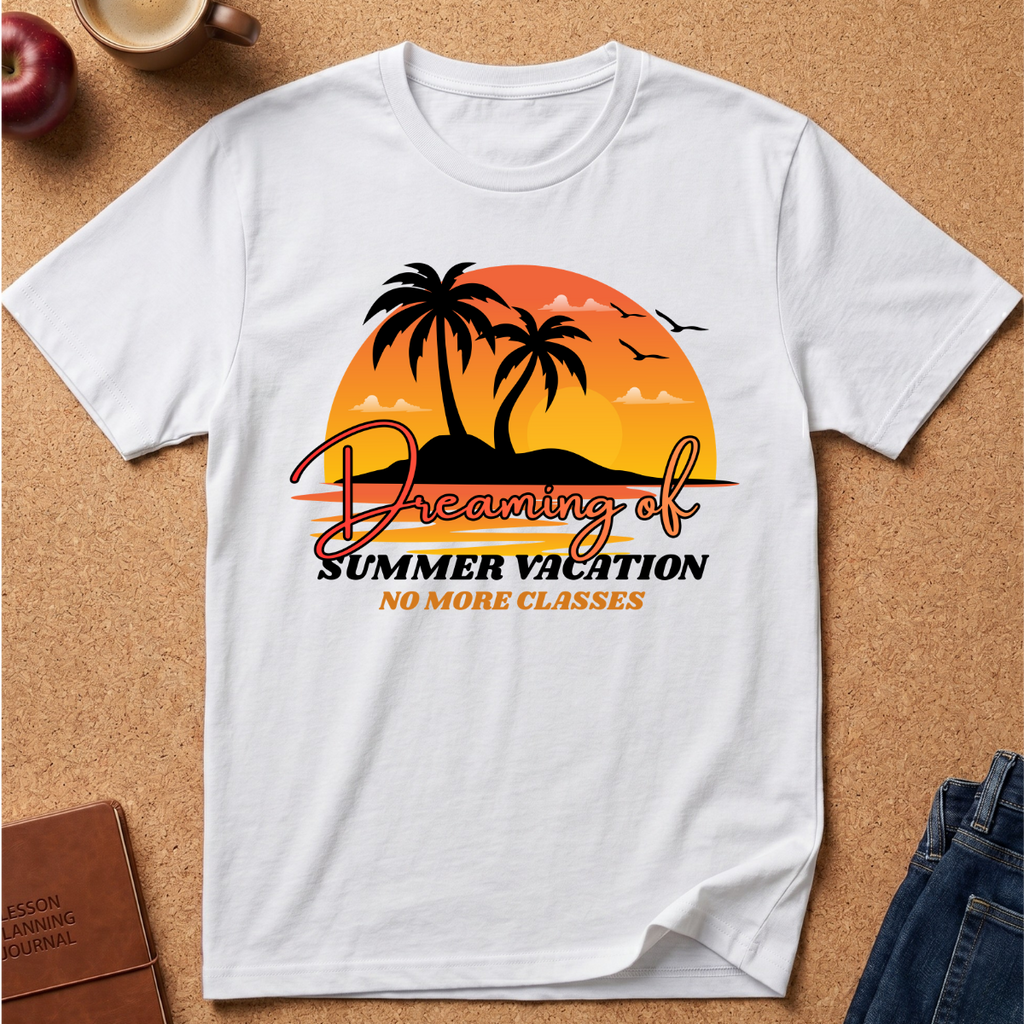 A white short-sleeve t-shirt laid flat on a cork background, featuring a retro-style graphic of two palm trees in front of an orange and yellow sunset with the text 'Dreaming of Summer Vacation NO MORE CLASSES'.