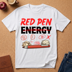 White graphic t-shirt with 'Red Pen Energy' with '20/50, F minus, No, Fail and X" scattered with a red pen and crumpled paper graphic design on a brown surface with an apple, coffee, and jeans.